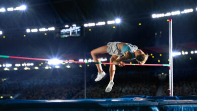 Championship: Professional Female Athlete on World Championship Successfully Jumping over Bar. Shot of Competition on Stadium with Sports Achievement Experience. Determination of Champion.