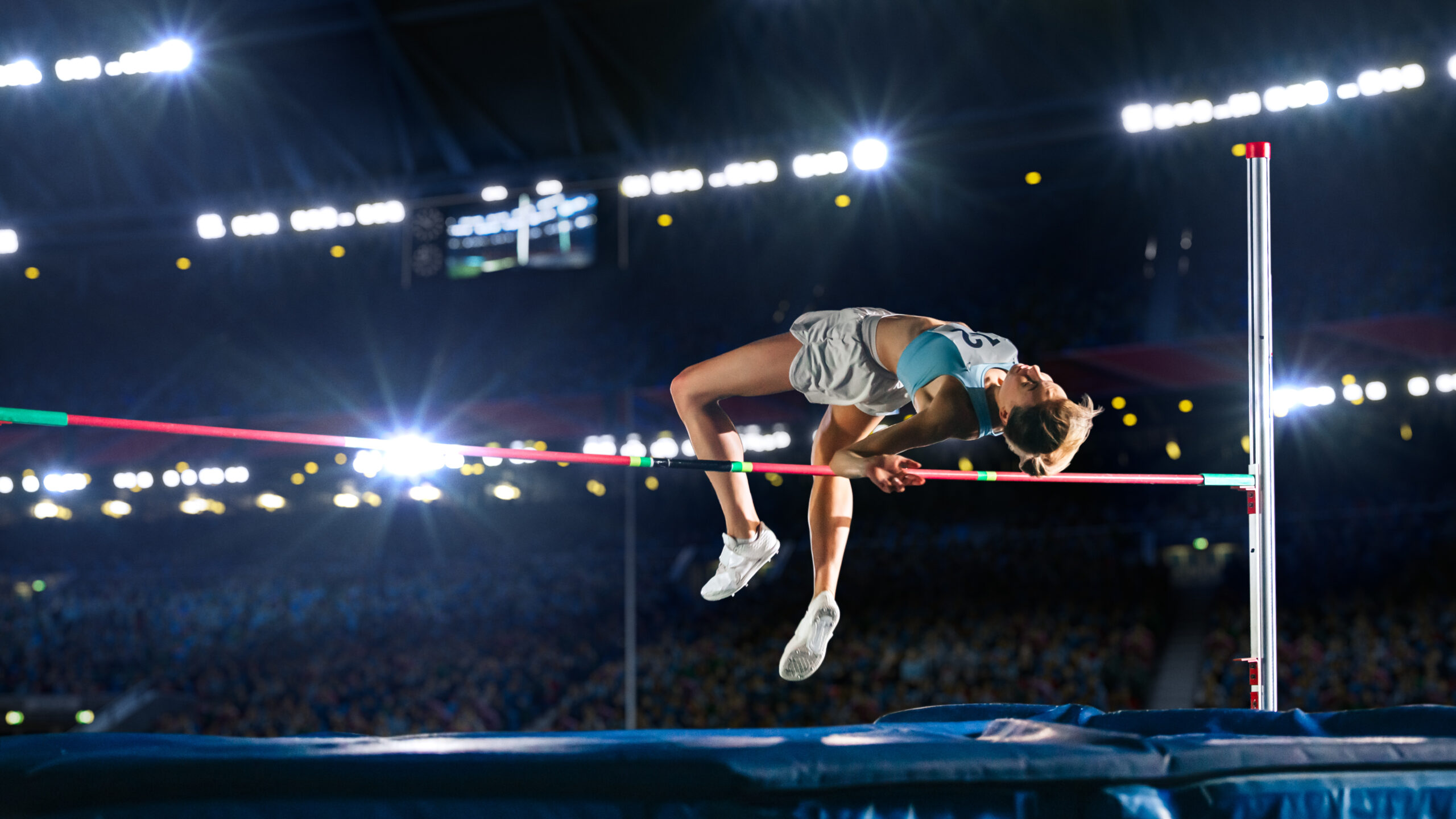 Championship: Professional Female Athlete on World Championship Successfully Jumping over Bar. Shot of Competition on Stadium with Sports Achievement Experience. Determination of Champion.