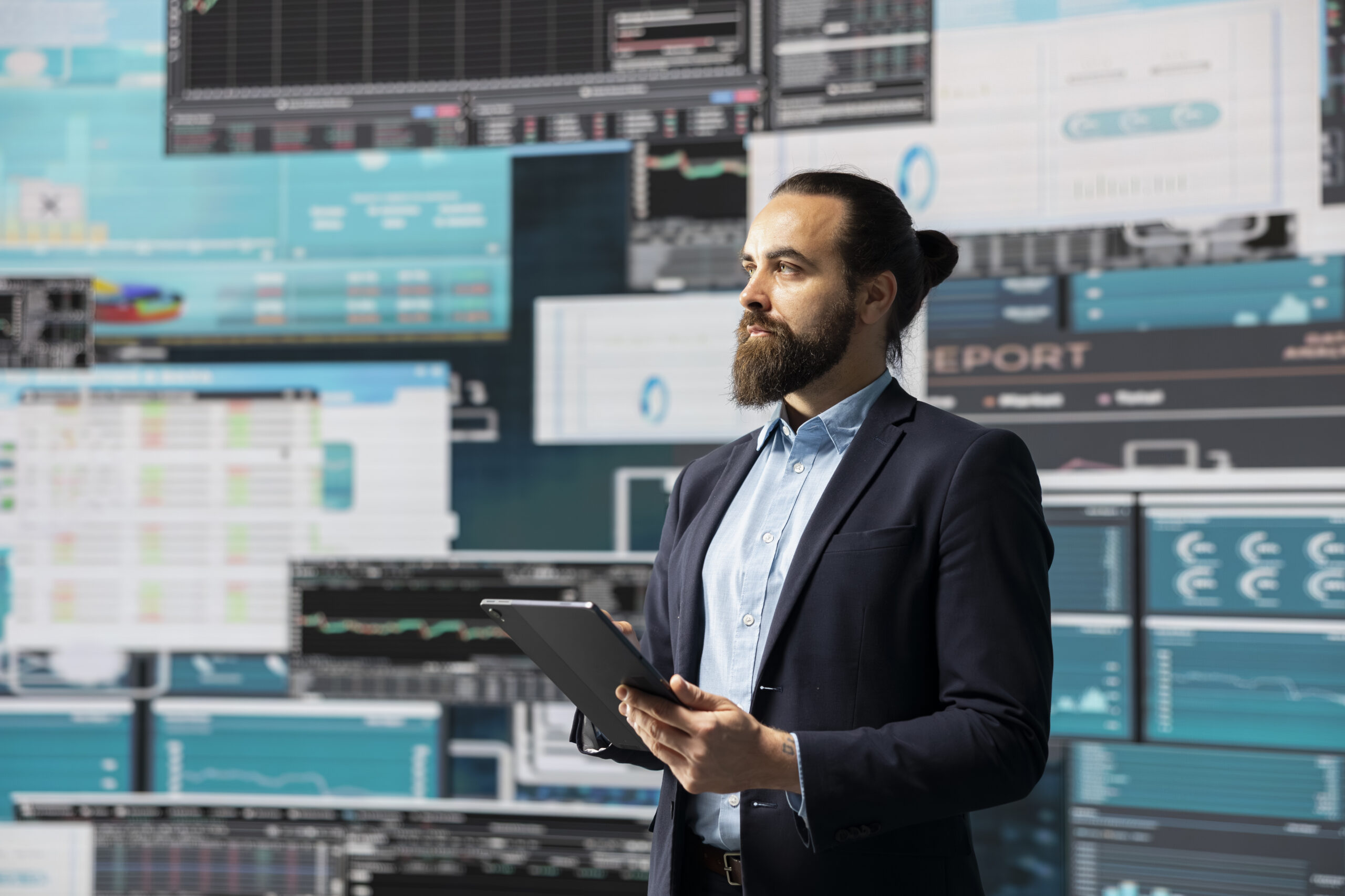 Surrounded by fintech data and forecasting models, entrepreneur analyzes data and insight to drive business growth. Company performance and smart decision making through innovation. ©Dragos Condrea iStock Getty Images Plus