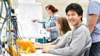 Portrait of young Asians in vocational training, in the background group of apprentices and teacher in class