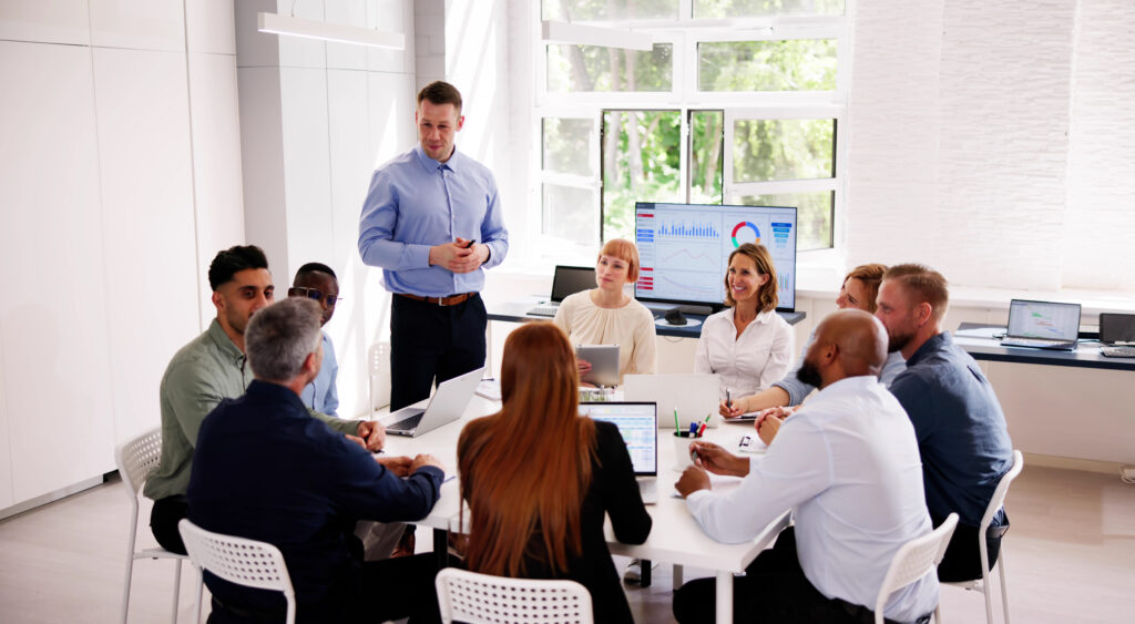 Company Inside Meeting In Office Boardroom. Diverse Business Team